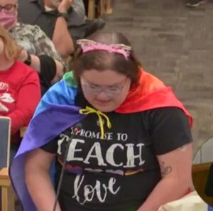 Teacher wearing rainbow cape